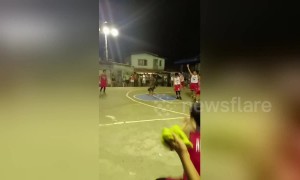 Basketball referee does cartwheels and splits when a player scores