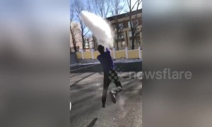 Hot water freezes in midair and turns into a cloud before blowing away