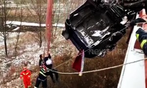 Firefighters rescue driver trapped in semi-trailer hanging off snowy motorway