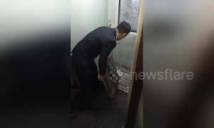 Train door in China freezes solid and has to be broken out by staff