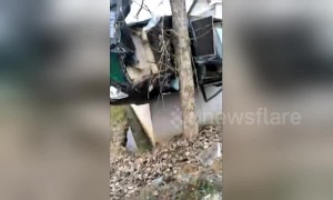 Car crashes off-road and gets wedged between a tree and a wall