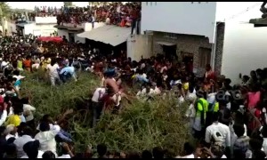 Indian villagers jump into huge pile of thorns from rooftops in bizarre ritual