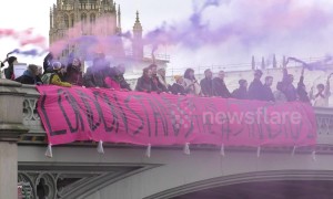 Protesters drop banner from Westminster Bridge in support of Stansted 15