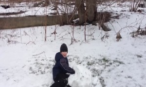 Boy Faces off with Big Snowball