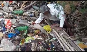 Elderly man slogs to save calf from garbage covered pond