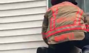 Fire Department Captain saves dog stuck on top of roof