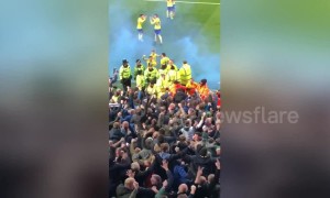 Chaos at Villa Park as Leeds grab late winner with flares thrown on the pitch and fans piling towards players