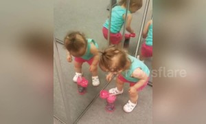 This little girl doesn't quite understand mirrors