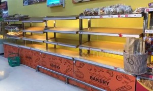 Stranded tourists stockpile food as supermarket shelves are emptied on storm-hit Thai island