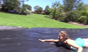 Young Australian girl makes slip 'n slide for cousins