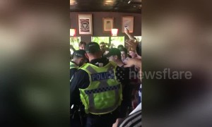 Crowd erupts in victorious cheers after police search fails to unearth flares