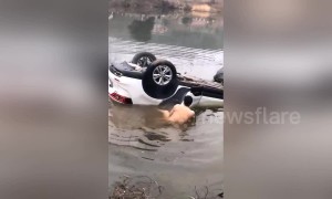 Man saves father and daughter trapped in car after vehicle loses control and dives into pond in southern China