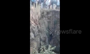 Incredible moment car driver is pulled up alive after plunging into 60-feet well