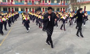 School pupils do choreographed shuffle dance with principal during break