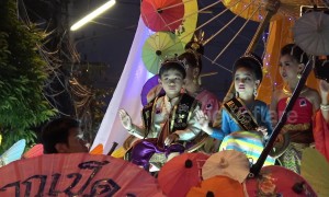 Thai locals wear traditional dress for evening parade at umbrella festival