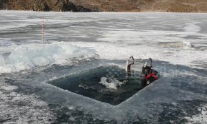 Russian man swims 25m under ice at world's deepest lake