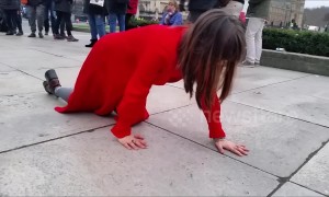 Mystery of the "lady in red" filmed crawling across Parliament Square in London