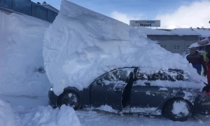 Parked car reverses while under 6ft-high snowdrift in Austrian hotel car park