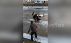 Villagers save man trapped in car that fell into icy river