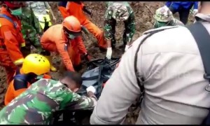 Search and rescue team evacuates landslide casualty in the wake of deadly Indonesia floods