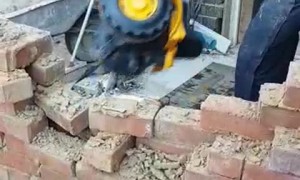 Worker Comically Demonstrates Demolition on Site