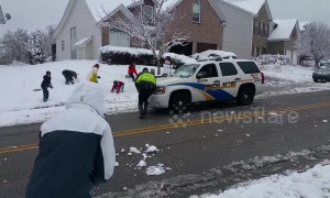 Friendly police join in snowball fight with neighbourhood kids