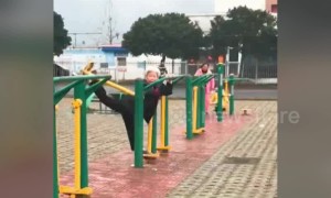 Flexible old Chinese woman does splits on training equipment