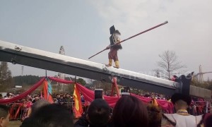 Kung fu master walks and does balance tricks on giant knife-edge