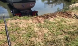 Semi Smashes Through Fence into Body of Water