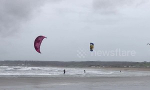Kite surfers make most of gale-force winds in Cornwall, UK
