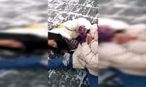 Tourists struggle to walk on slippery snow-covered Great Wall