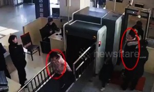 Naughty girl climbs through X-ray machine at train station