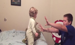 Silly Siblings Pretend to Knock over Baby