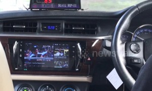 Bangkok taxi driver watches TV in his modified dashboard