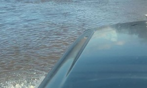 Truck Fords Through Flooded Roadway