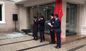 Cartoon-ish scene as man walks into glass door, shattering it during ceremony