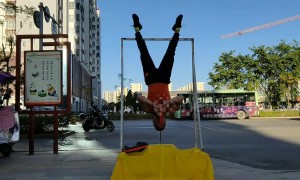 Kung fu master balances head on a nail then plays Chinese instrument