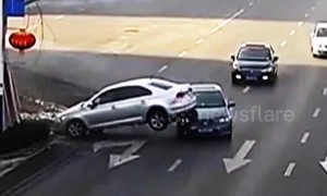 Distracted driver nearly flips car on embankment and lands on second vehicle