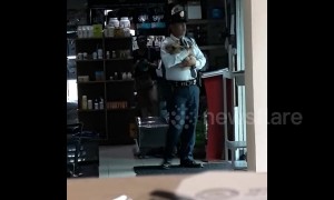Awwwww! Filipino security guard rocks troubled puppy to sleep