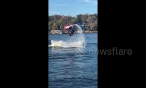 Jet skier makes a splash with a double flip during stunt jump attempt