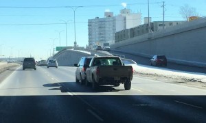 Truck Pushes Car Down Freeway