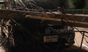 Driver has lucky escape after electricity post falls on his car