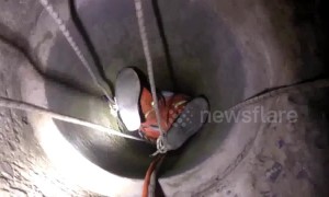 Fireman hangs upside-down to save old woman trapped in well in China’s Henan