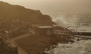 UK coastline thrashed by Storm Gareth during sunset