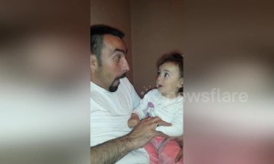 Dad and baby daughter trade funny faces in this utterly adorable clip