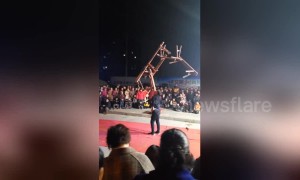 Chinese acrobat lifts up seven benches stacked onto his mouth
