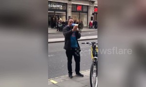 Passionate protester rants into megaphone outside Apple store in London