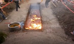 Woman falls into red hot coals during Indian festival