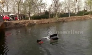 Firefighters save woman trapped in car that falls into lake
