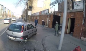 Speeding motorcycle nearly collides with vehicle